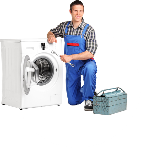A man is kneeling next to a washing machine holding a wrench.
