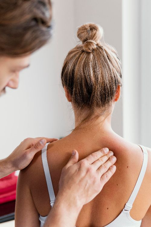 Massagista realizando massagem terapêutica.