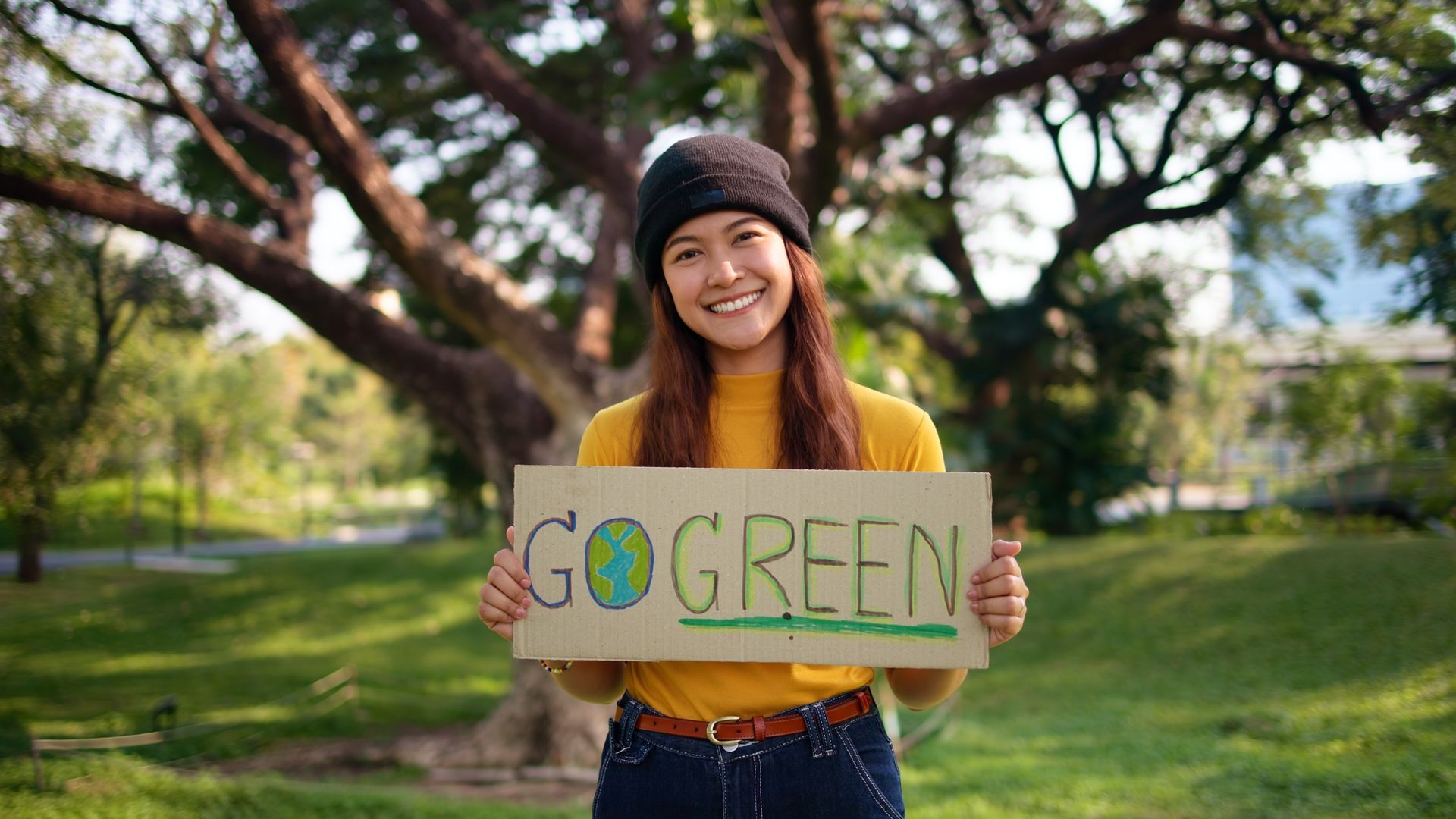 Girl holding Go Green sign