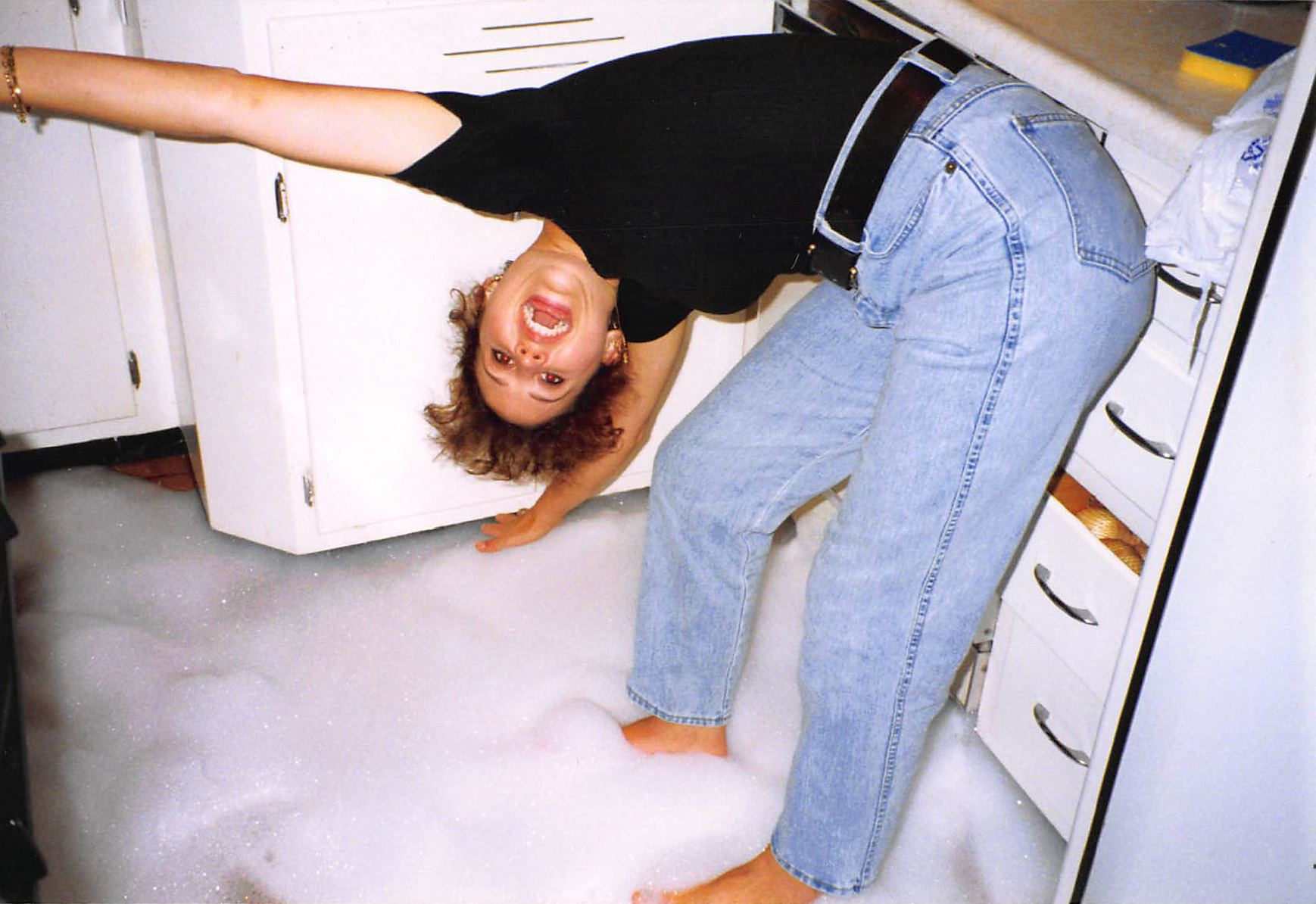 Weida staff member in early days in kitchen with bubbles on floor - Maintenance Requests
