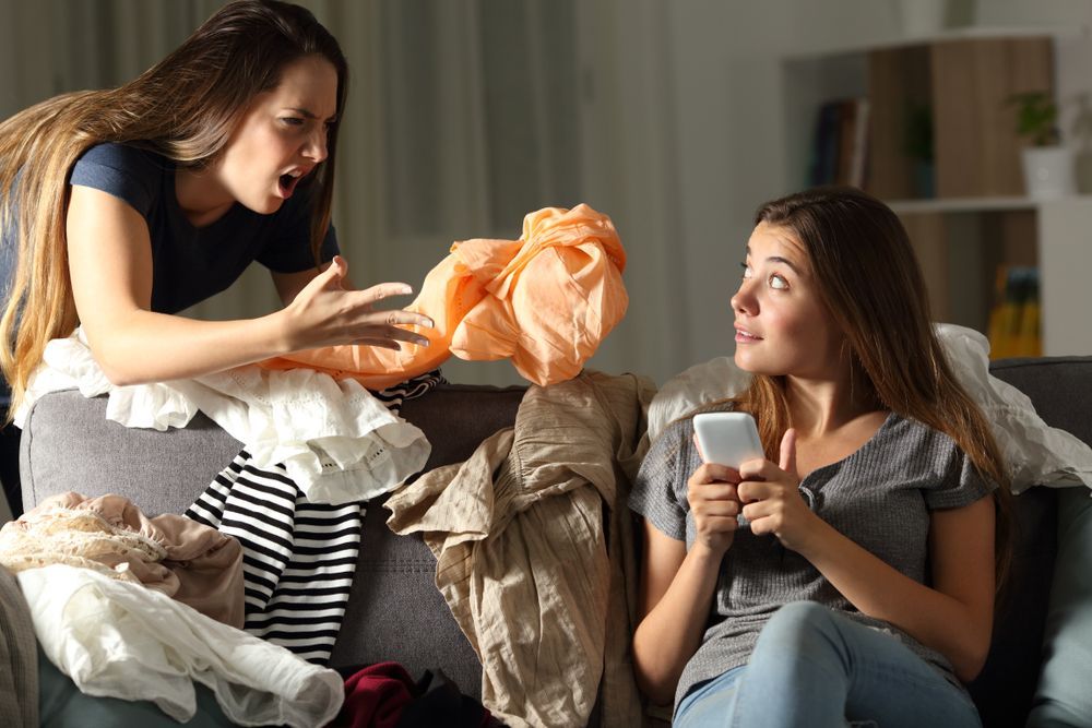 College roommates arguing about a messy apartment