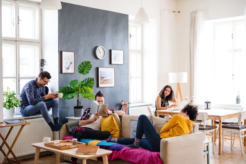 College roommates hanging out in the living room of their shared apartment together