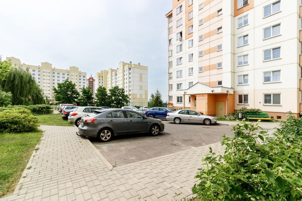 Parking for cars in the courtyard of an apartment building with cars standing on it