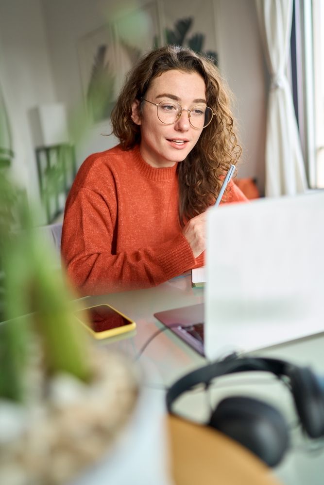 college student enjoying the privacy of her college apartment while she studies without disruptions