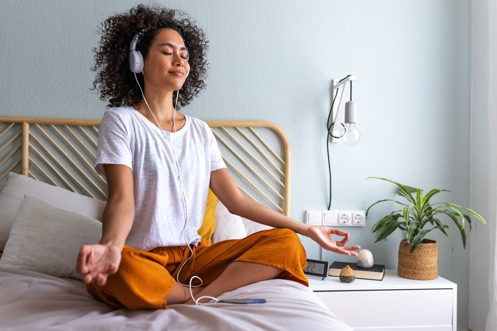 A college student practicing meditation as part of their morning routine.