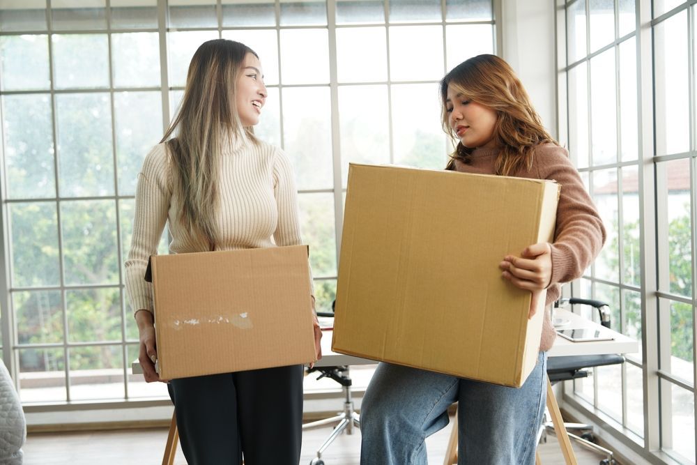 two female roommates moving out of their college apartment