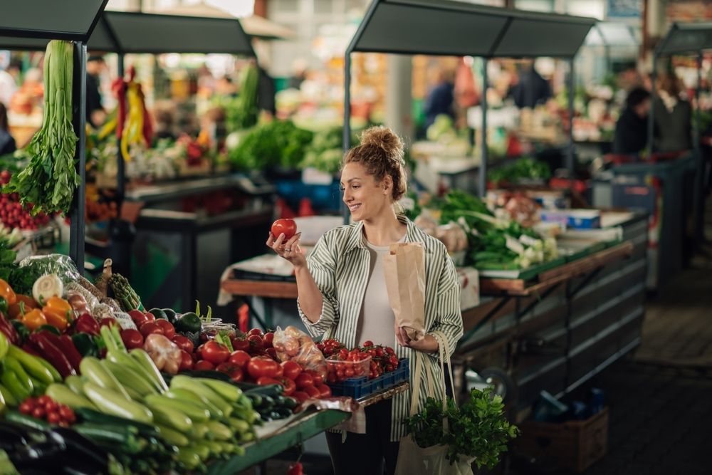 a woman shopping at a farmers market