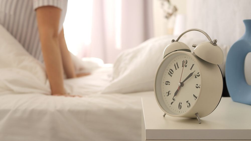 An alarm clock wakes up a college student.
