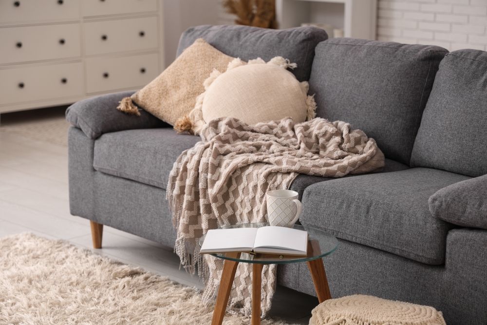 Winterizing an apartment by adding blankets and a rug.