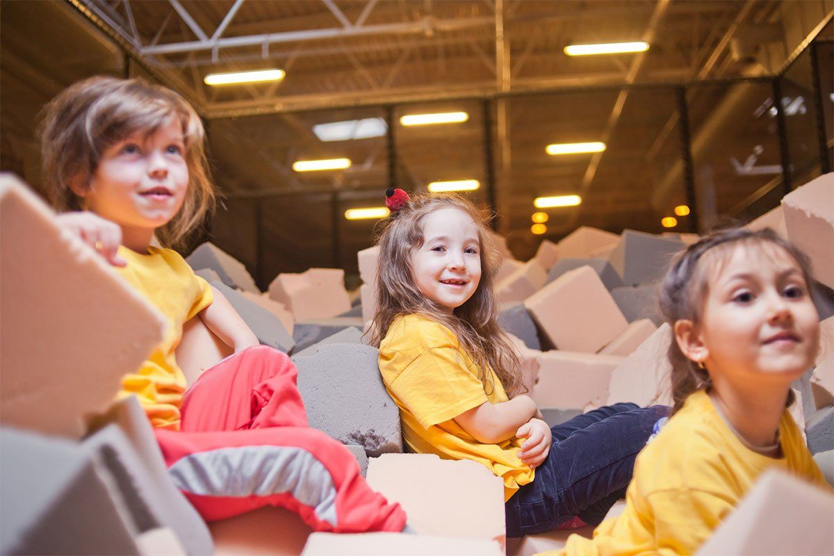 Kids Sitting in Foam Pit — Poughkeepsie, NY — Bounce Family Entertainment