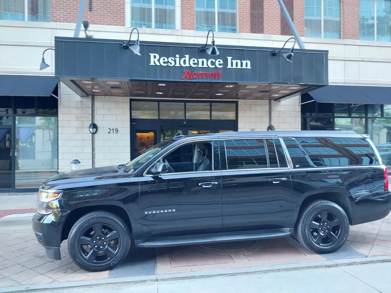 Black SUV in front of a Residence Inn hotel.