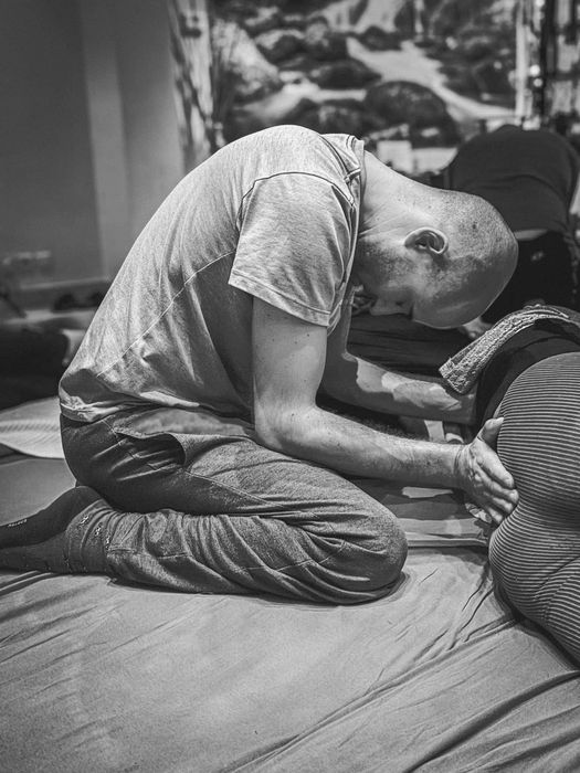 A man spaceholding as he supports a woman during her integration process, embodying care and presence in a ConSensual session.