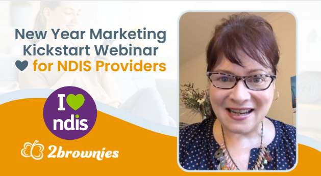 Ness, the General Manager of 2Brownies is smiling with a sign that says NDIS New Year Marketing 