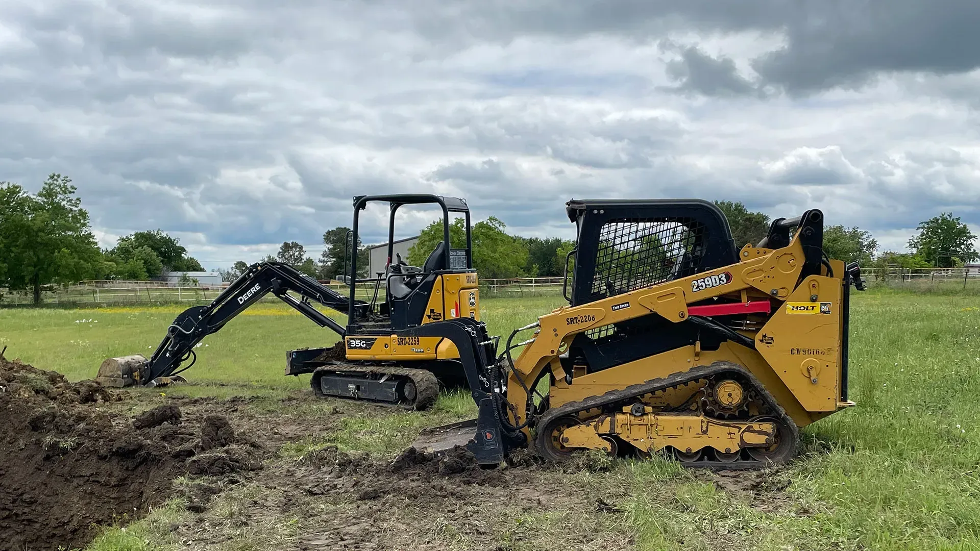 A track loader and mini excavator on an excavation site near Conroe, Texas.