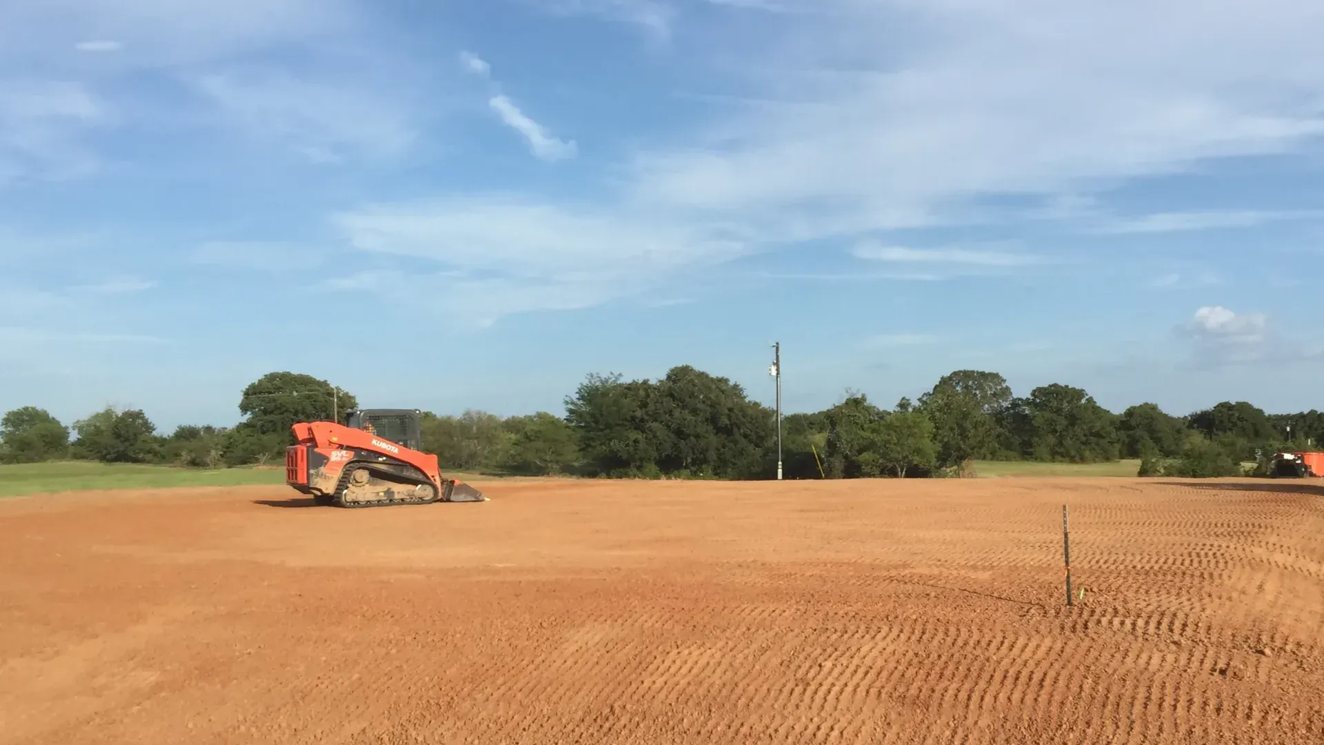 An excavating company preparing a residential house pad in Conroe, Texas.