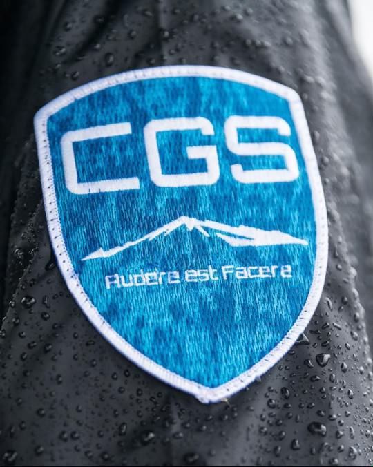 A patch on a jacket that says cgs on it