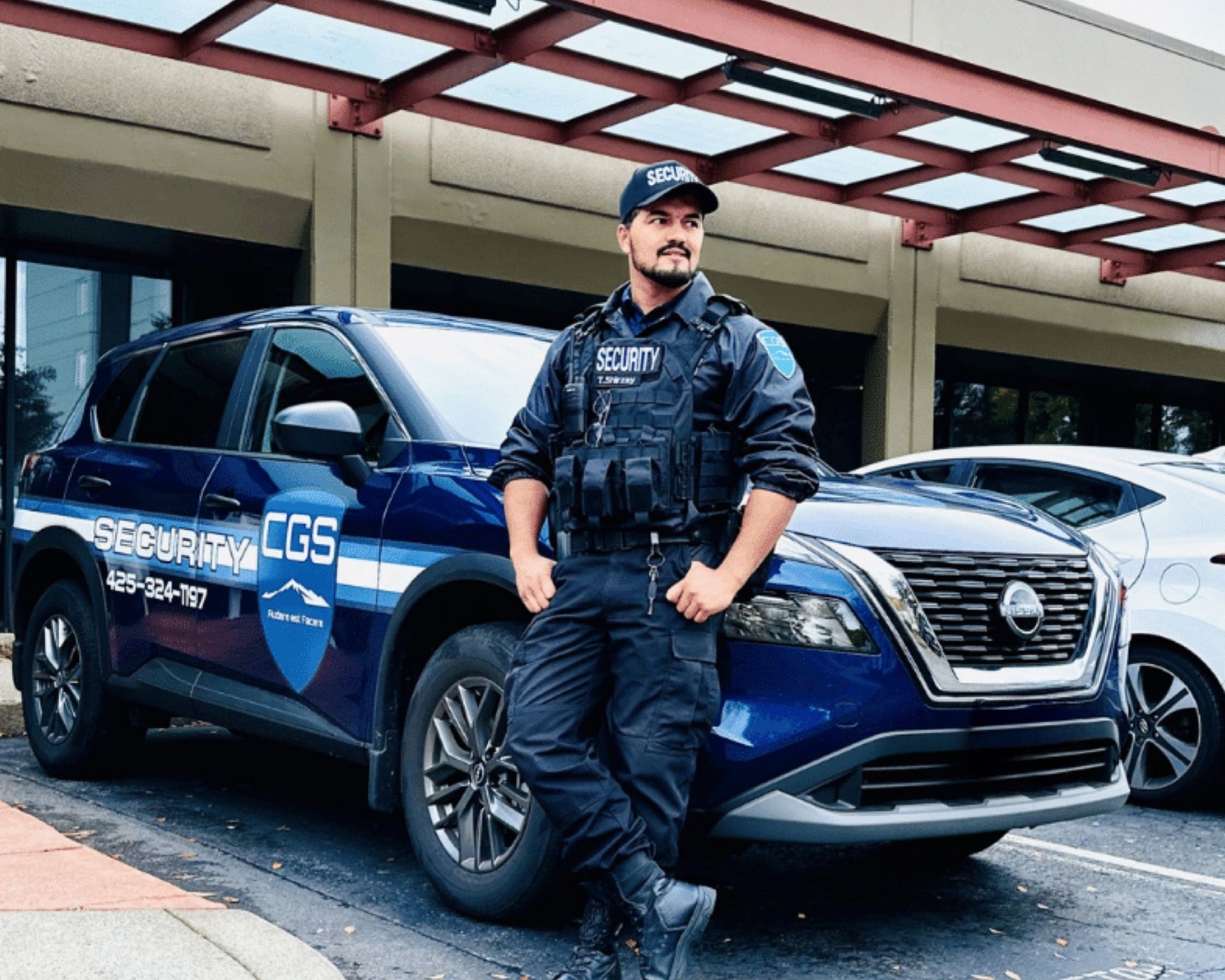 A man in a security uniform is standing next to a blue suv.