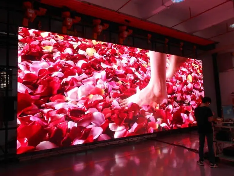 A large screen with a picture of a woman 's feet on it