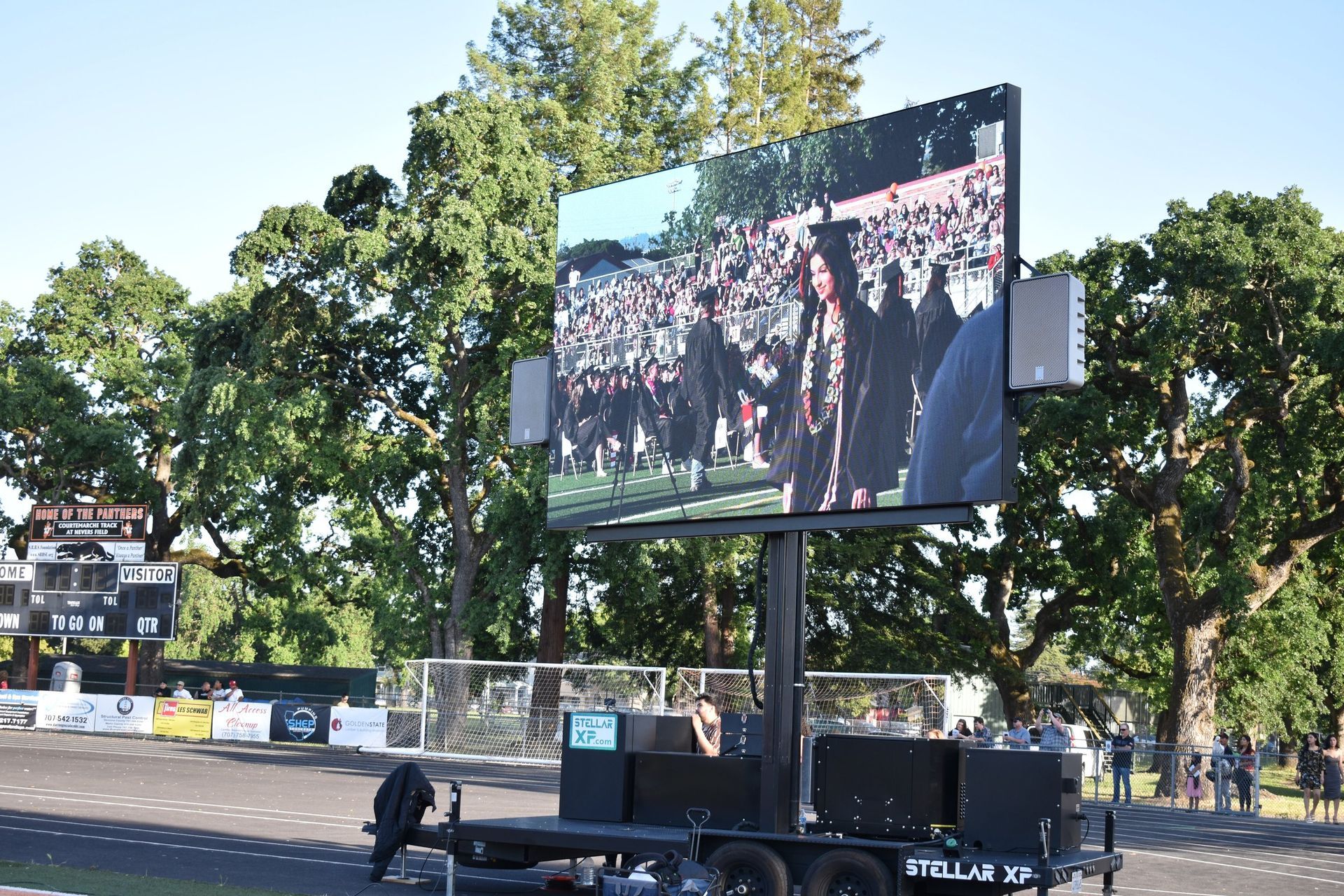 A large screen is sitting on top of a trailer.