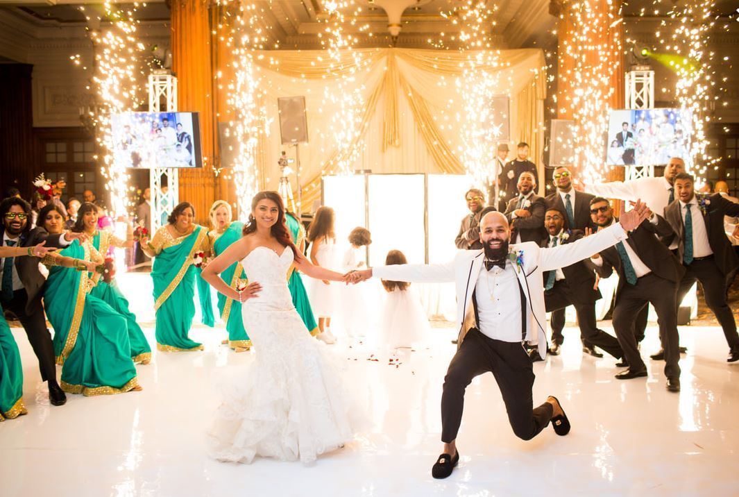 A bride and groom are dancing on a dance floor at their wedding reception.