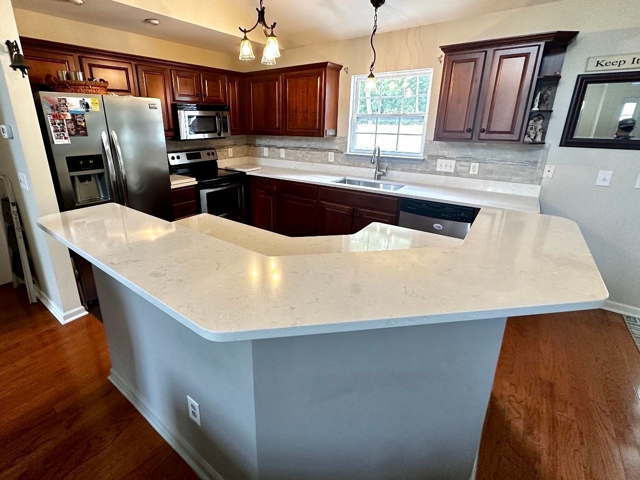 A kitchen with a large island in the middle of it.