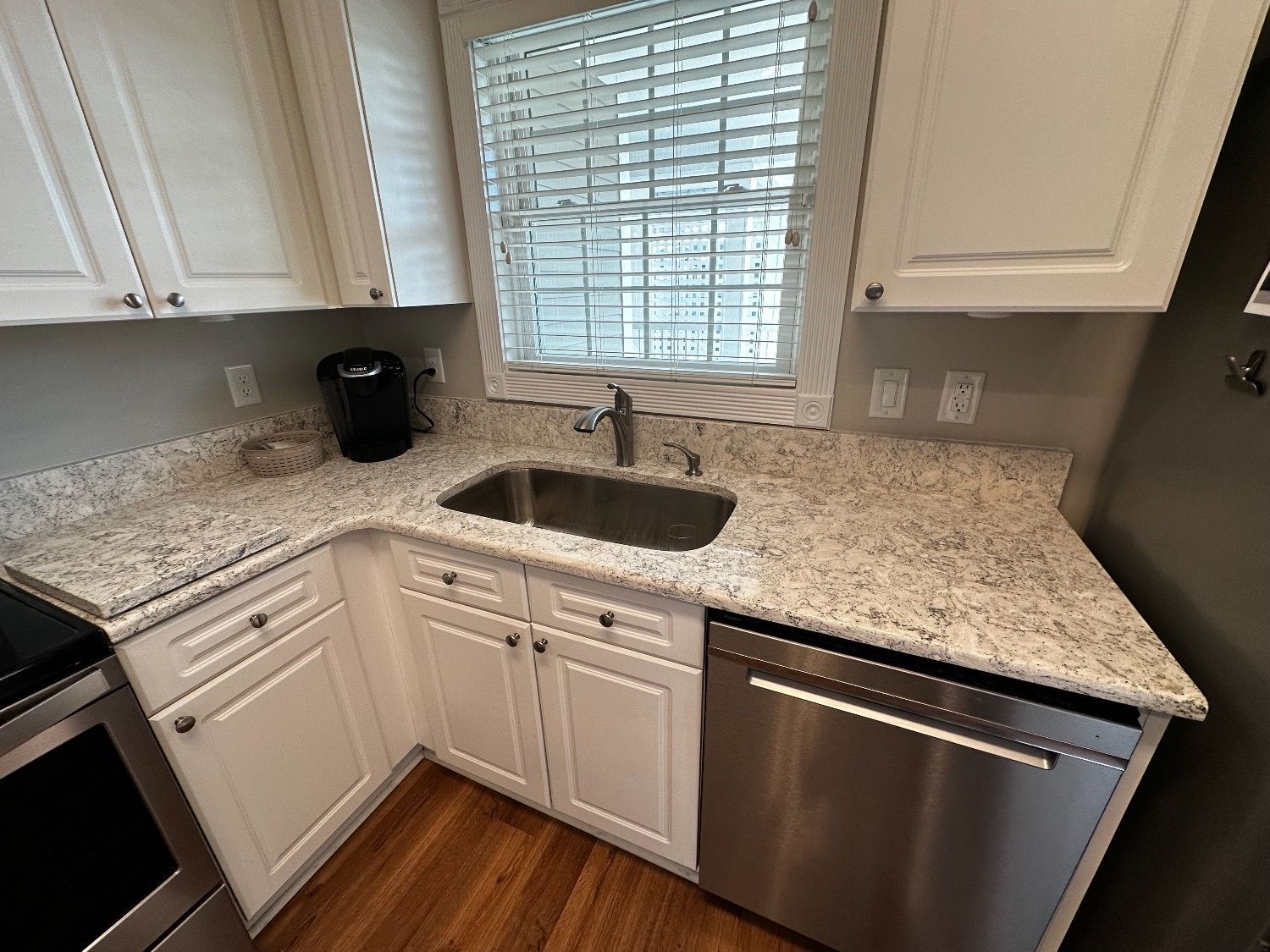 A kitchen with granite counter tops and stainless steel appliances