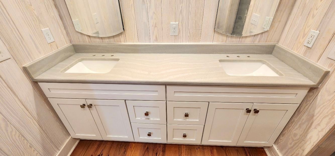 A bathroom vanity with two sinks and two mirrors.