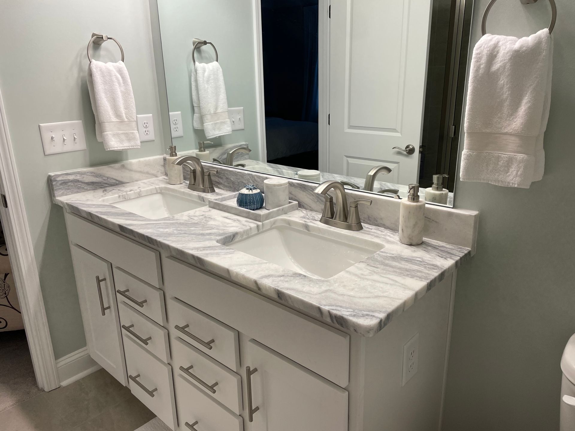 A bathroom with two sinks and a mirror.