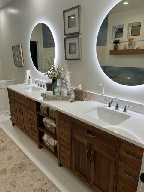 A bathroom with two sinks and two mirrors