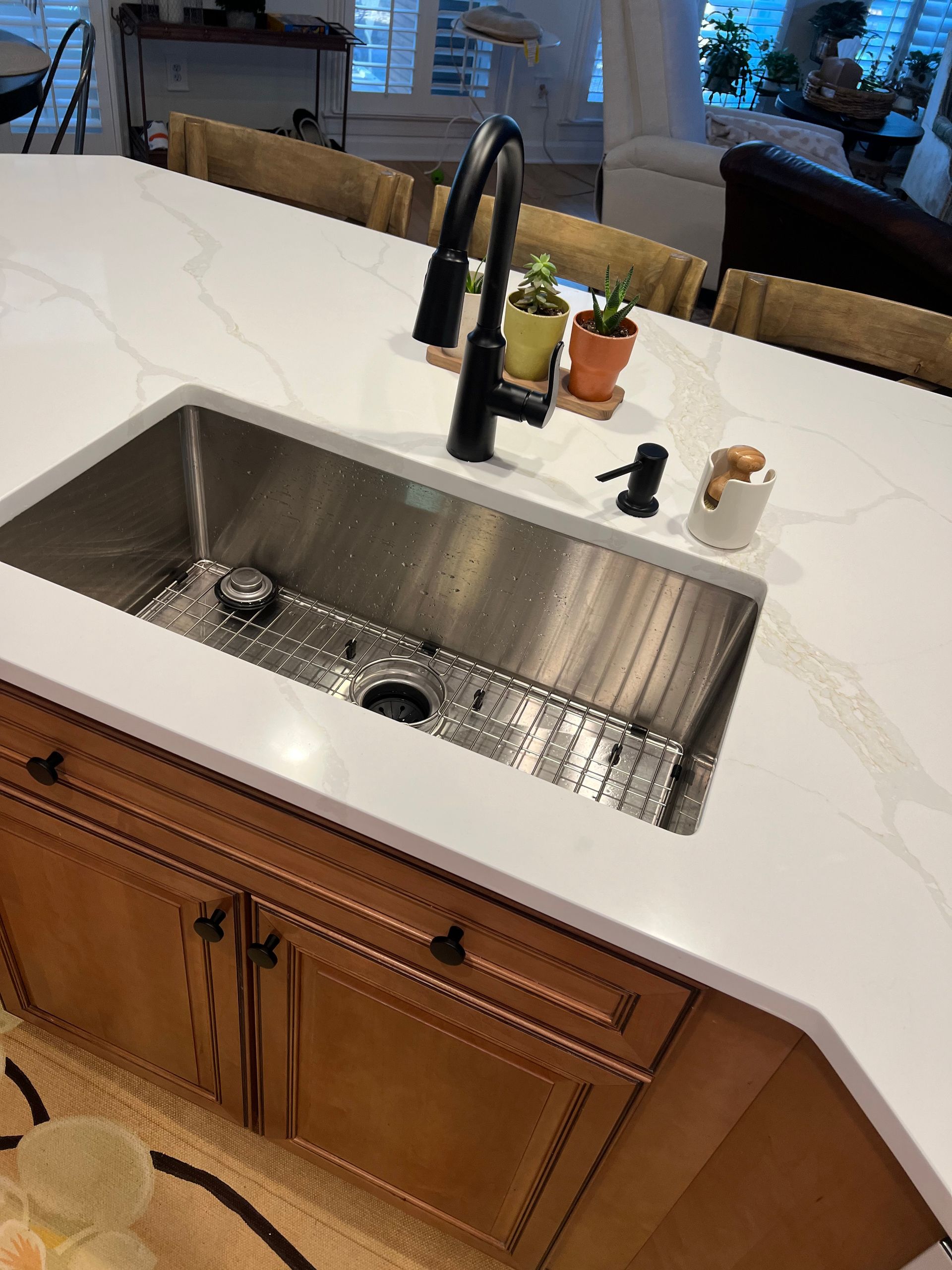 A kitchen with a stainless steel sink and a faucet.