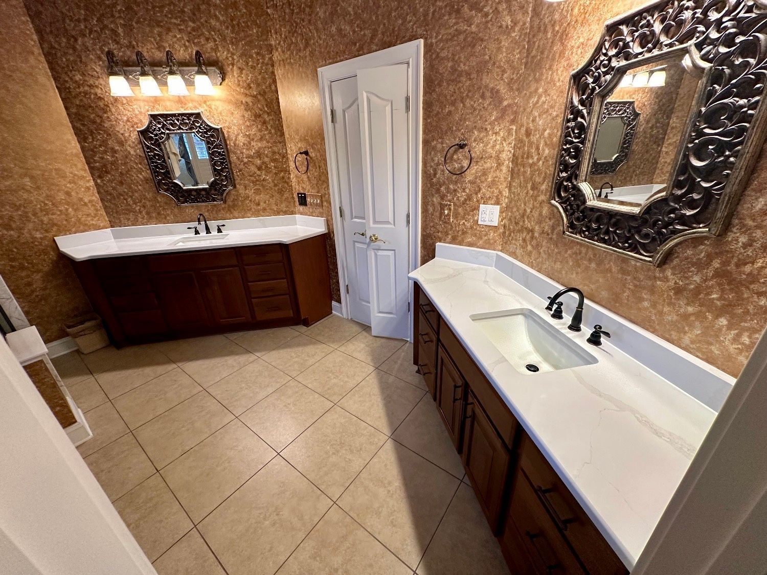 A bathroom with two sinks and two mirrors.