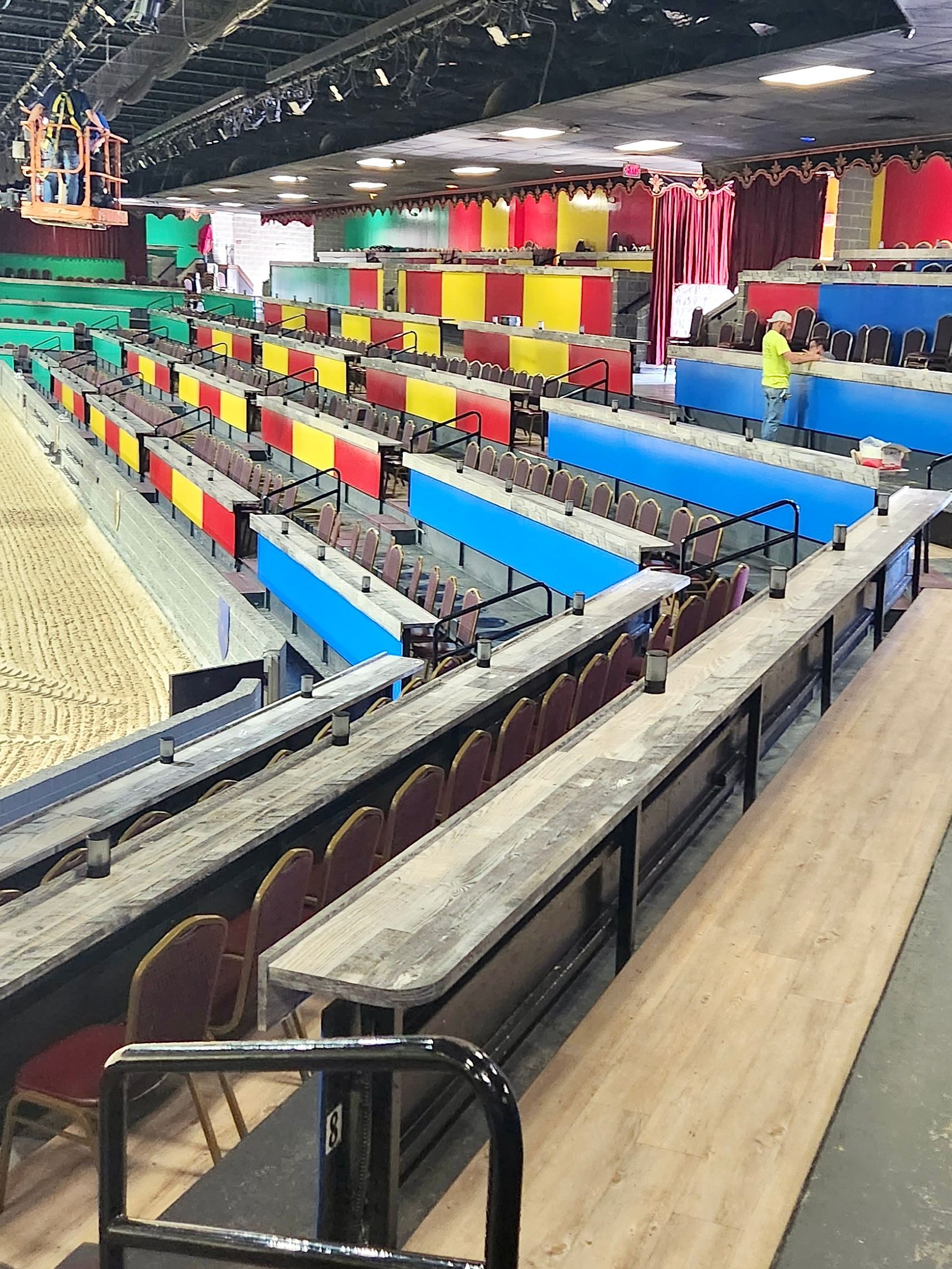 A row of bleachers in a stadium with colorful seats.