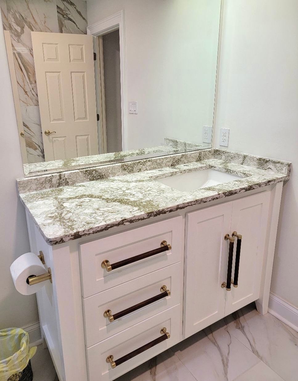 A bathroom vanity with a sink and a mirror.