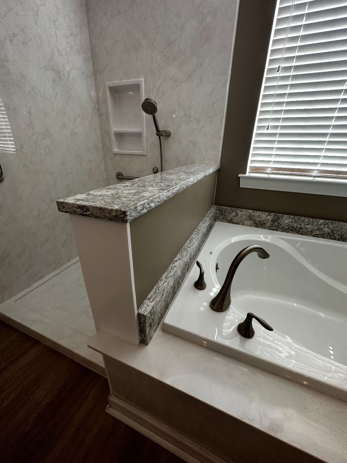 A bathroom with a tub , shower and window.