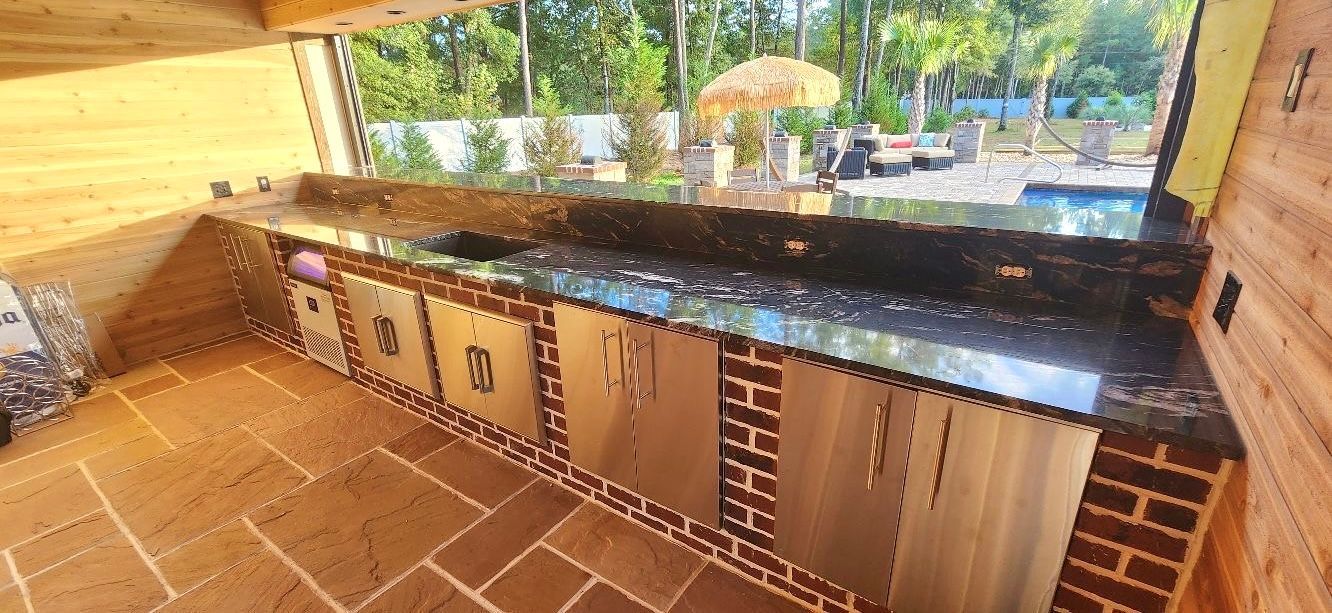 A kitchen with stainless steel cabinets and granite counter tops.