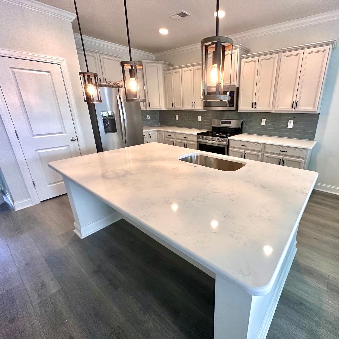 There is a large island in the middle of the kitchen.