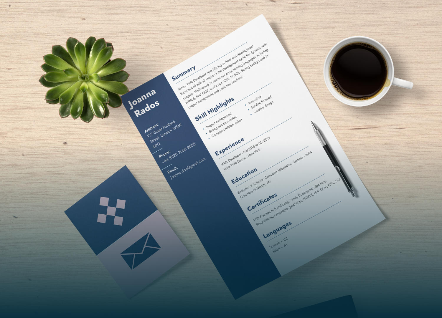 Resume with blue sidebar and business cards next to a cup of coffee and a succulent on a wooden table.