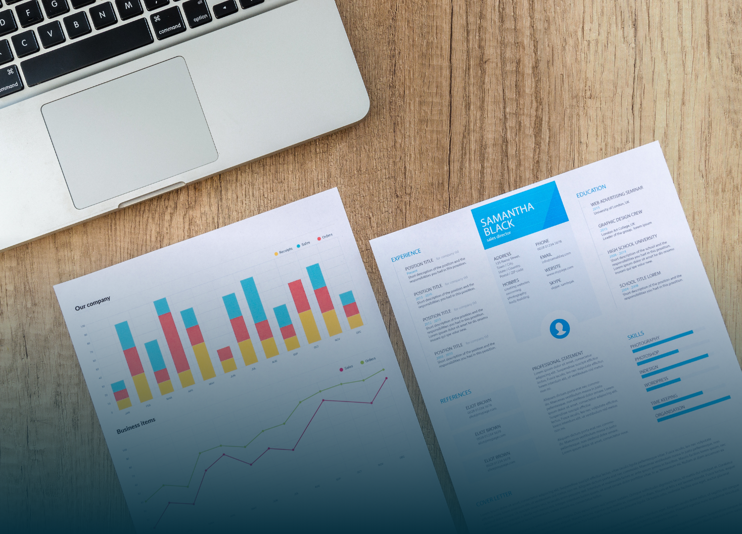 Laptop next to a resume and chart on a wooden surface, suggesting job application or data analysis.