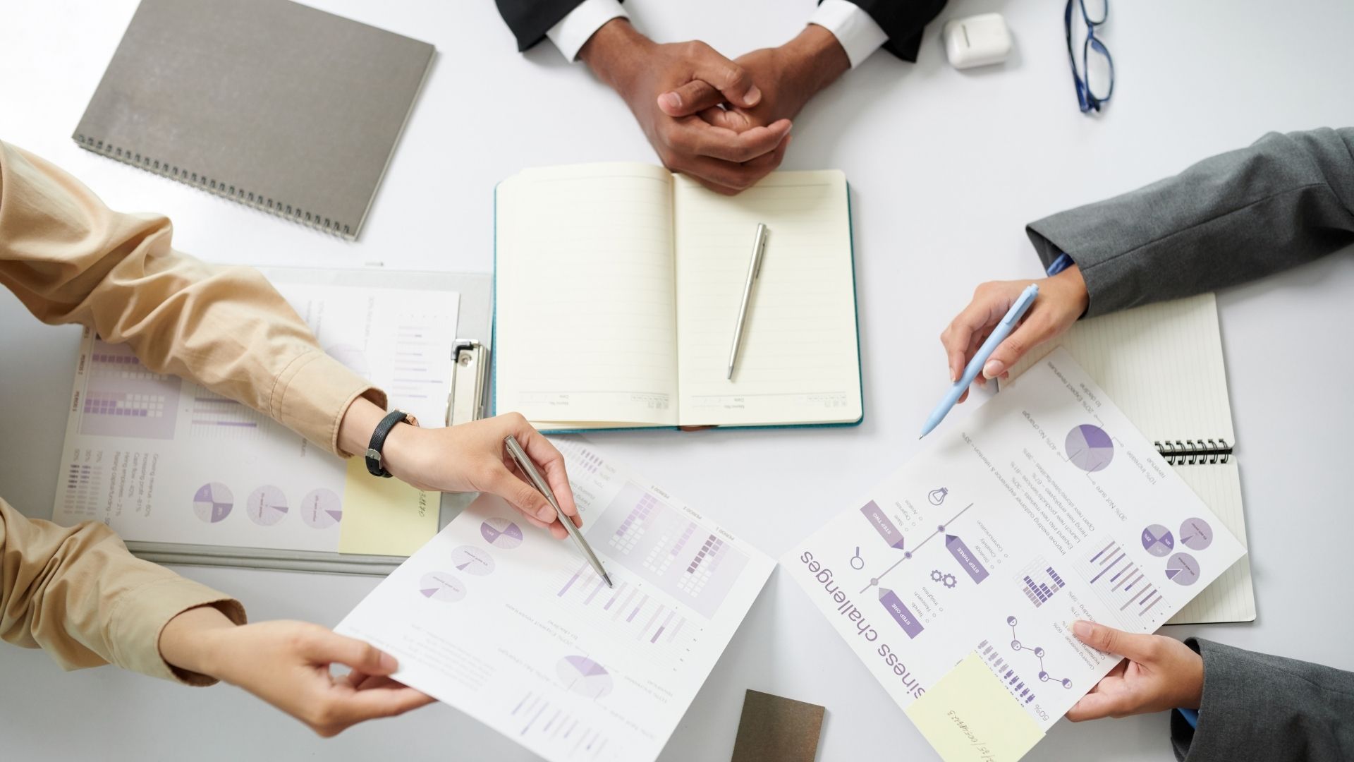 City skyline over water with overlaid stock market graphs, blue sky.