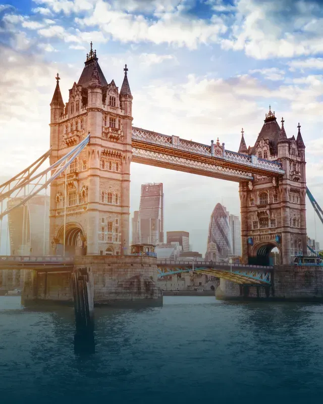 Tower Bridge, London, England, spans the Thames River; sunny day.