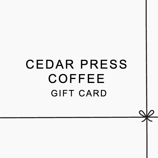 Cedar Press Coffee gift card on a white background with simple black text and ribbon line detail