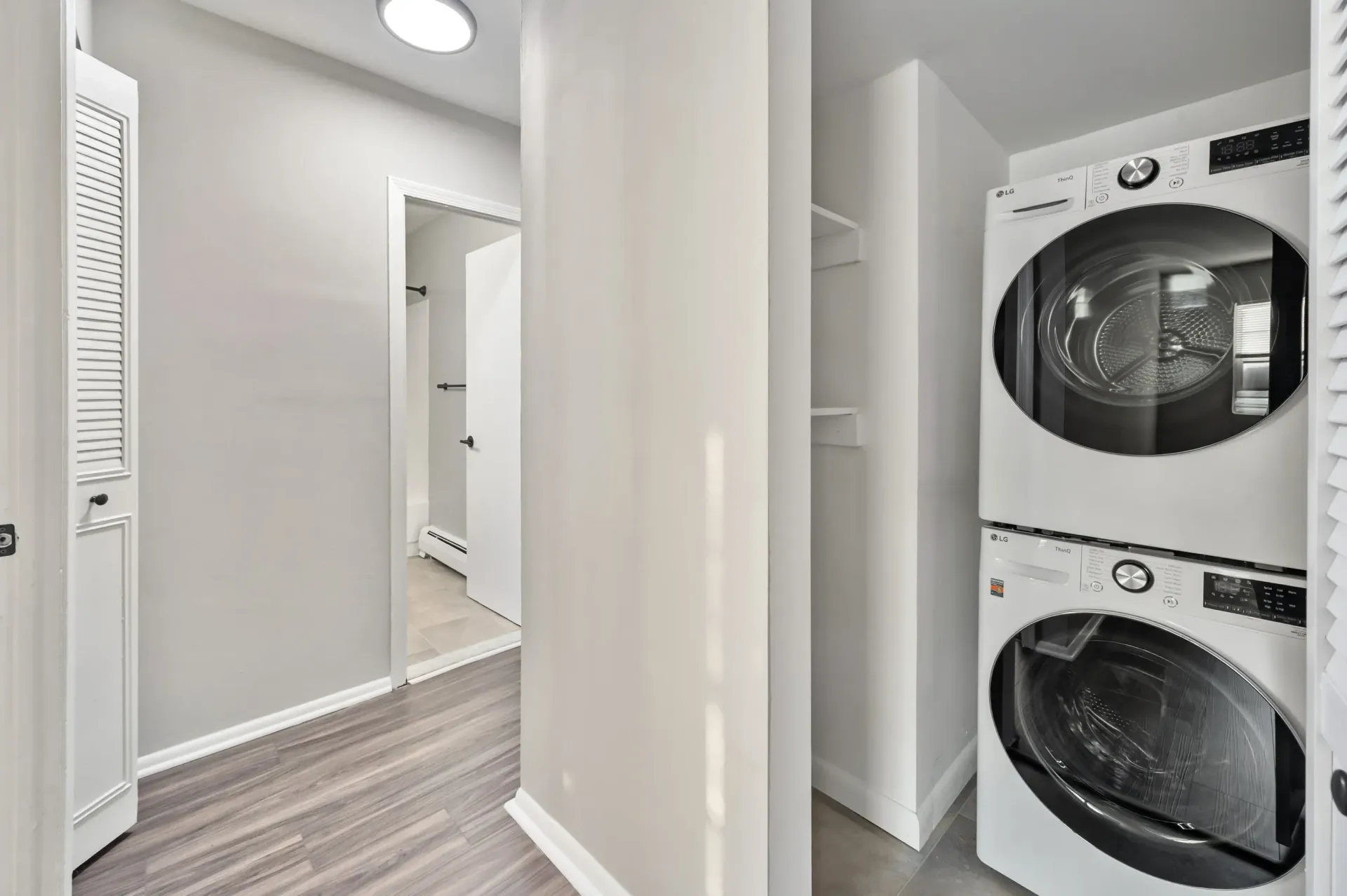 In-unit laundry closet with stacked washer and dryer.