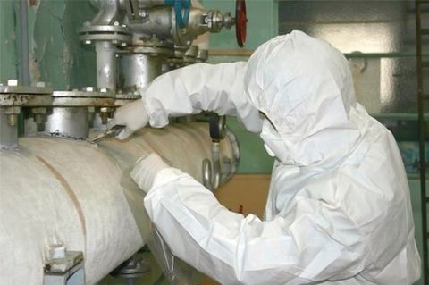 man in white protective suit inspecting asbestos- Charleston, WV