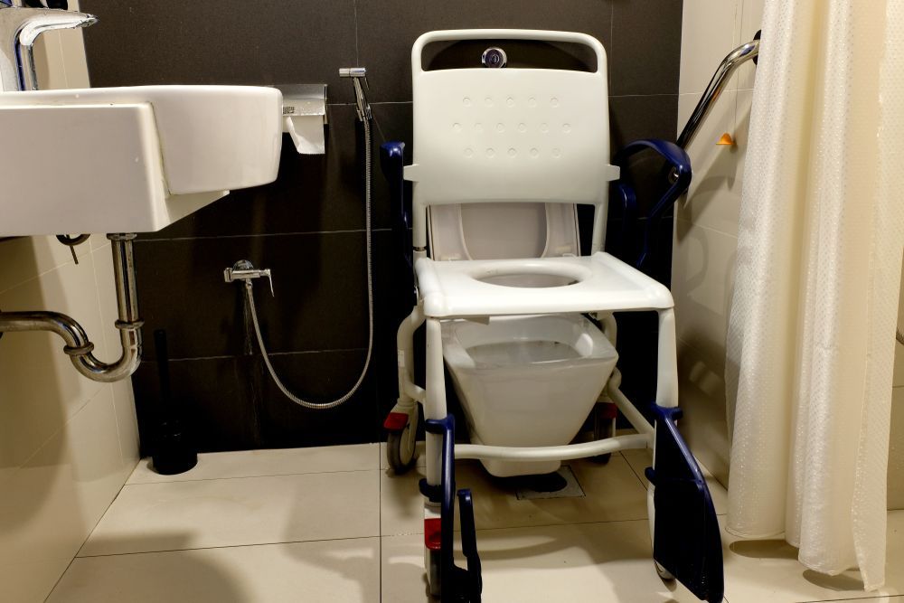 Accessible Bathroom With a Commode Chair — Sonke Support Pty. Ltd. in Noosa Heads, QLD