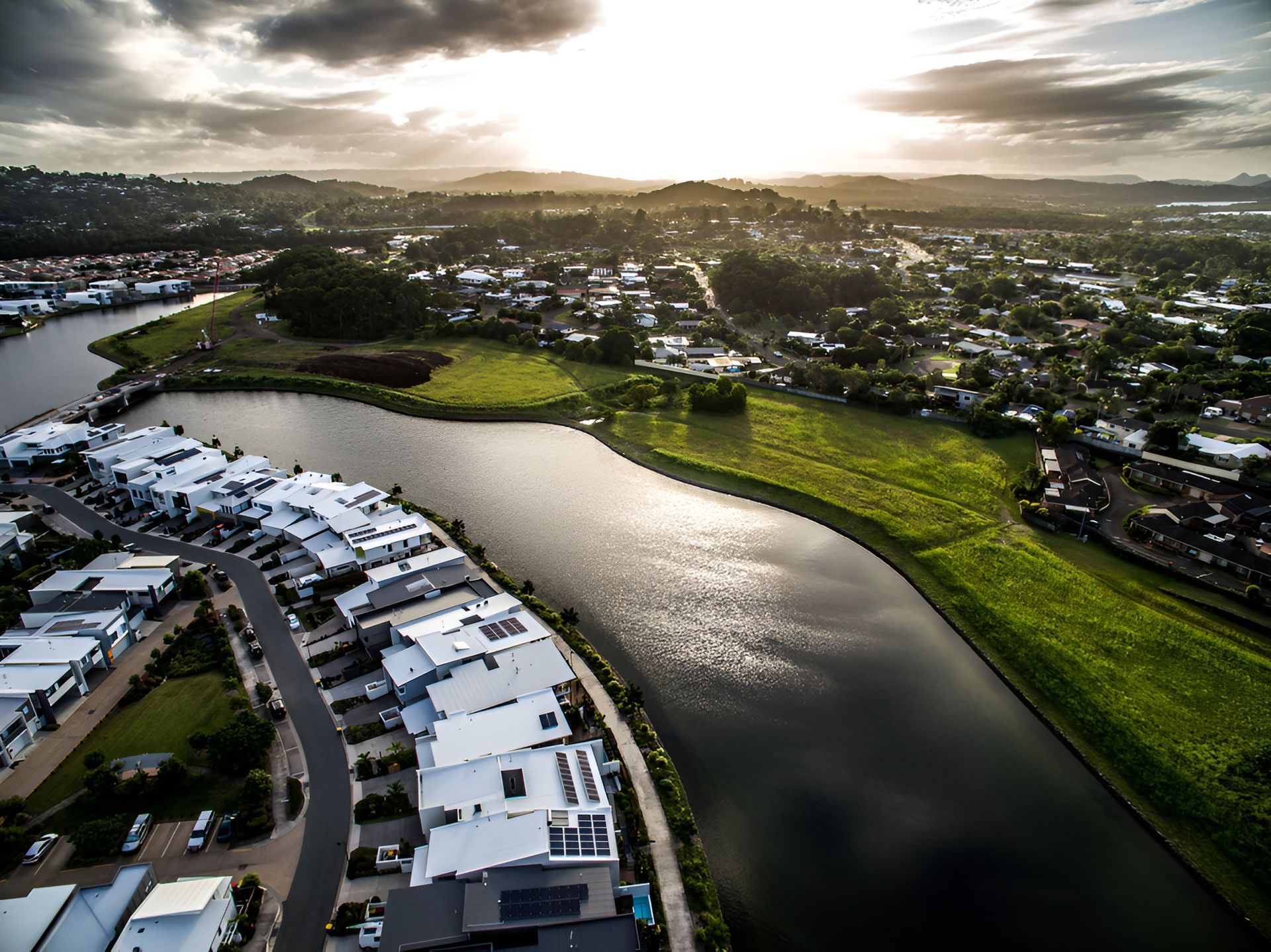 Aerial View of a Town With White-roofed Houses Along a Dark River — Sonke Support Pty. Ltd. in Buderim, QLD