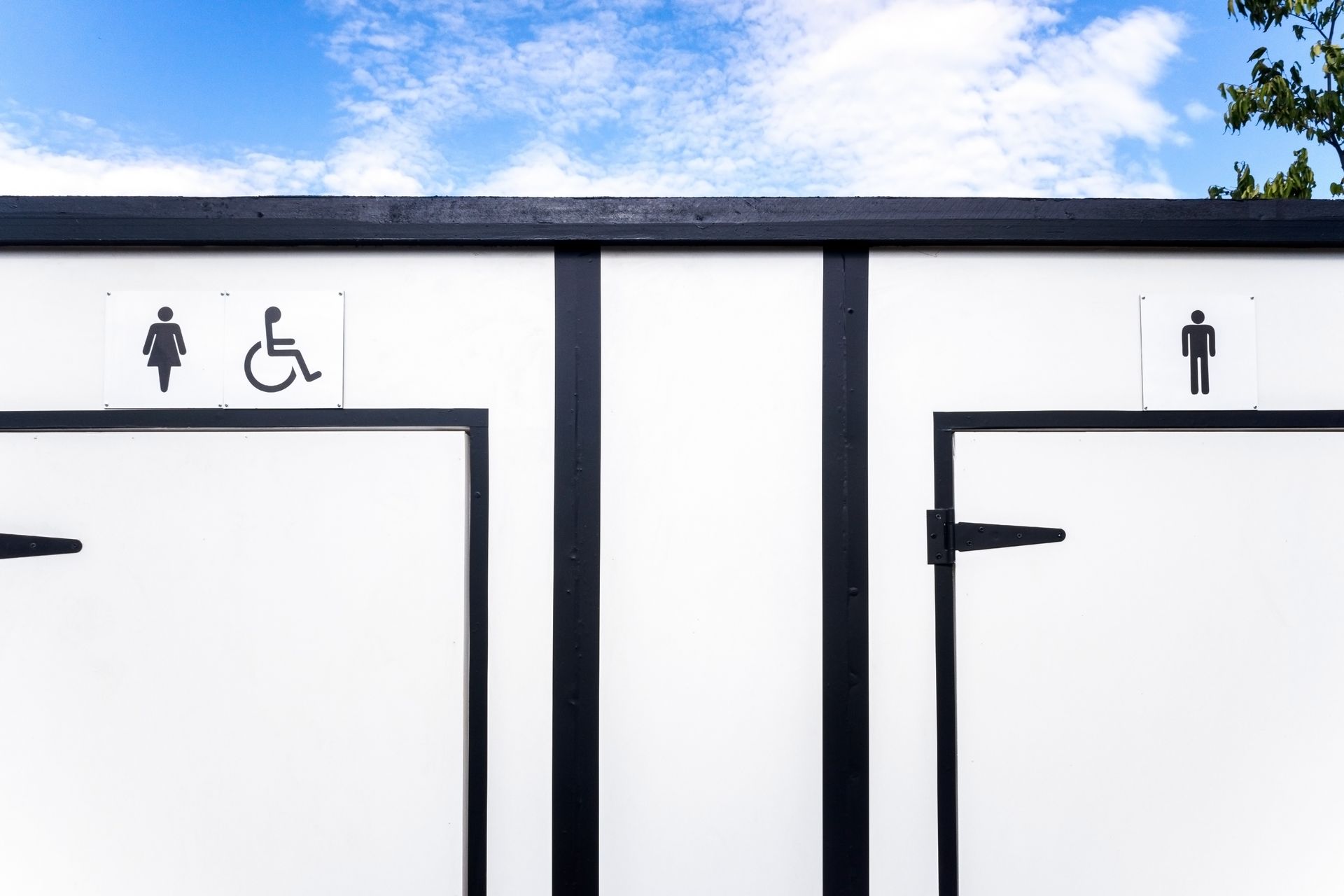 White Public Restroom Doors With Gender and Accessibility Symbols — Sonke Support Pty. Ltd. in Noosa, QLD
