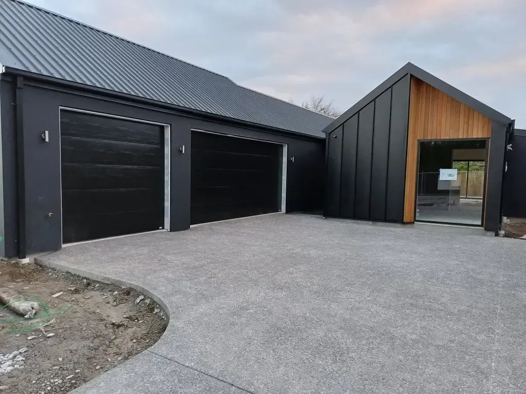 A large house with a lot of garage doors and a driveway.