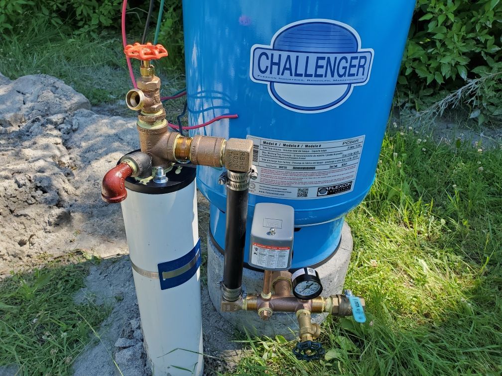 Plumber assembling connection for water well to household water system.