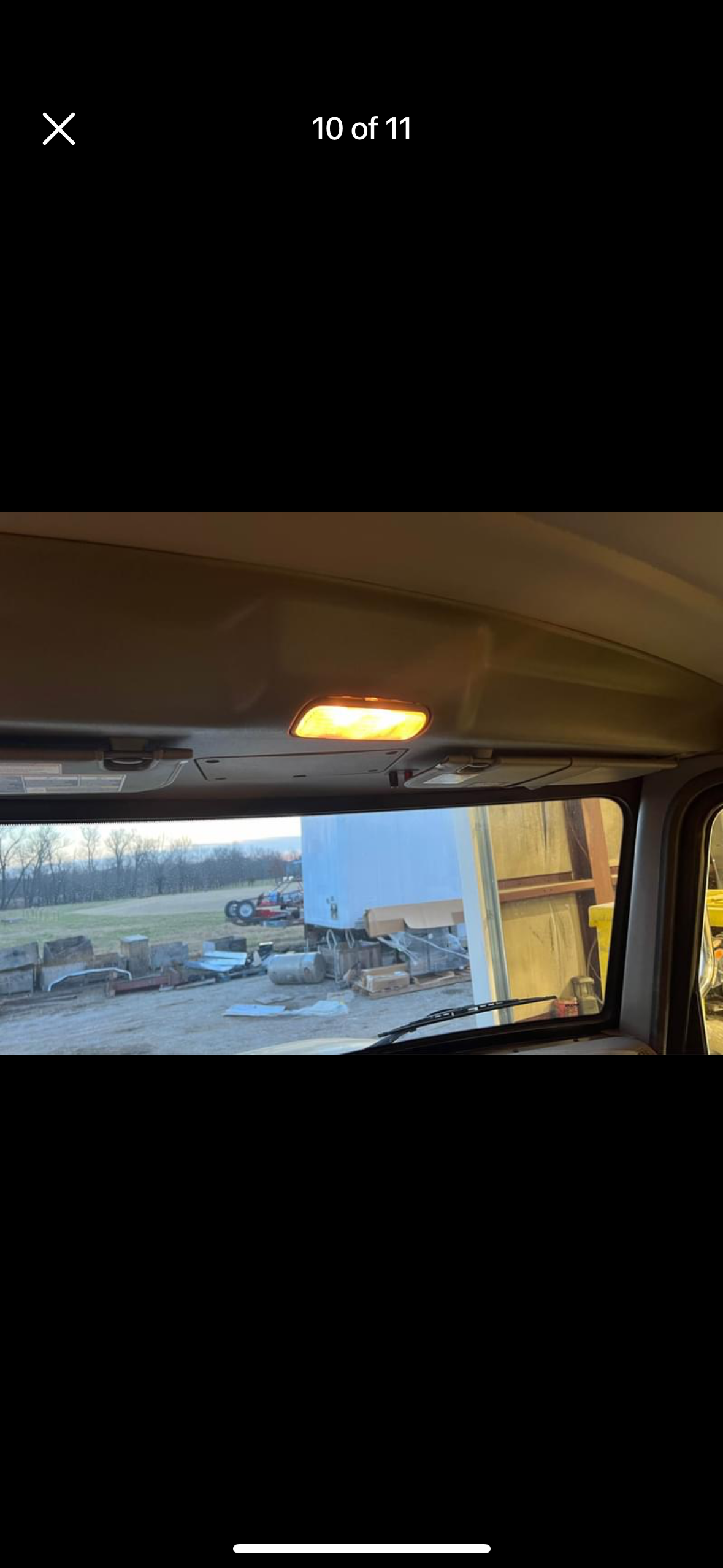 A picture of the inside of a car with a roof light on.