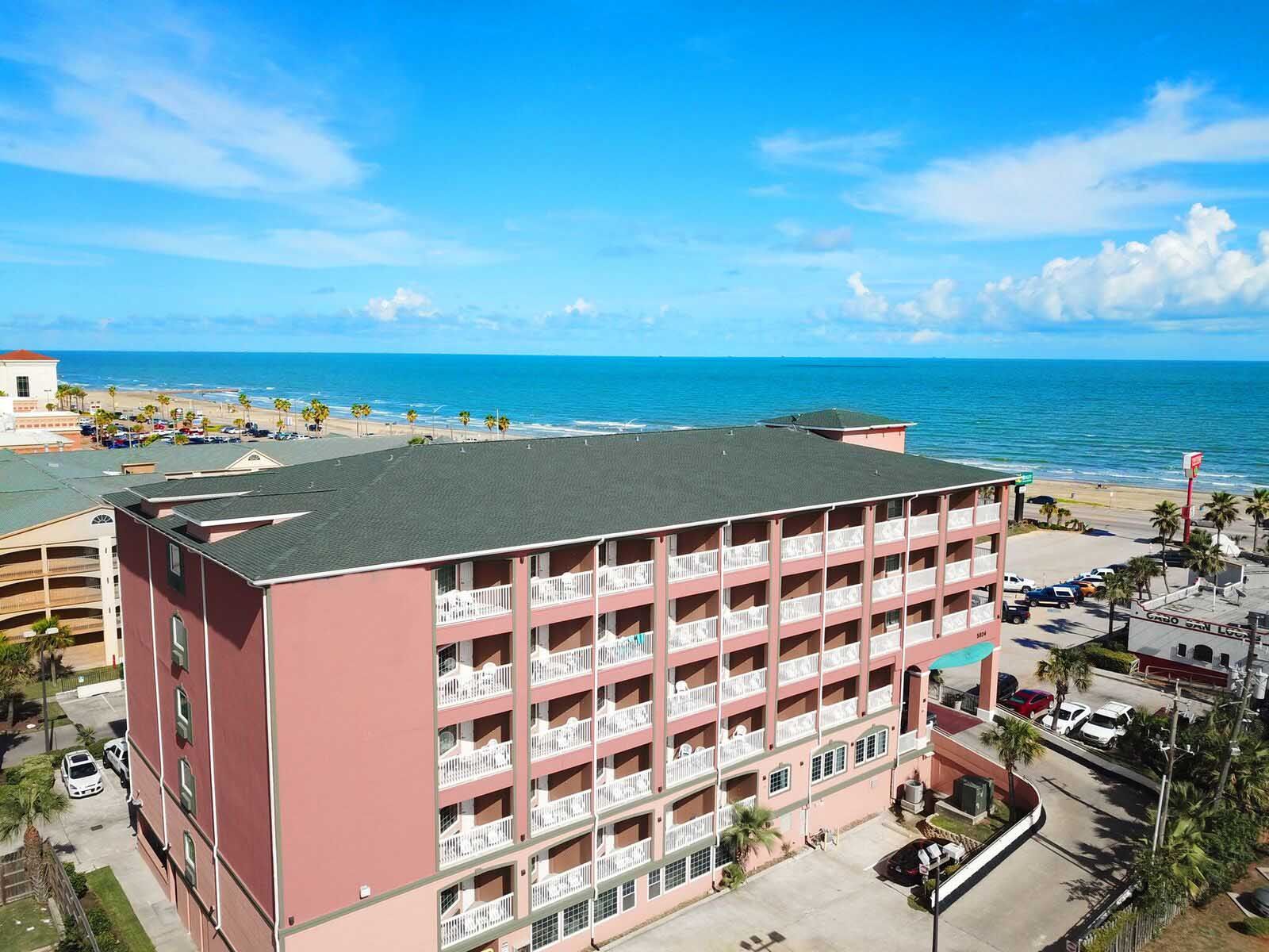 An aerial view of a hotel with a view of the ocean.